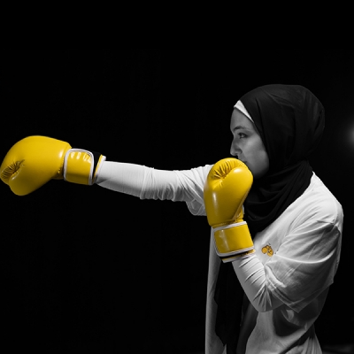 Student wearing yellow boxing gloves