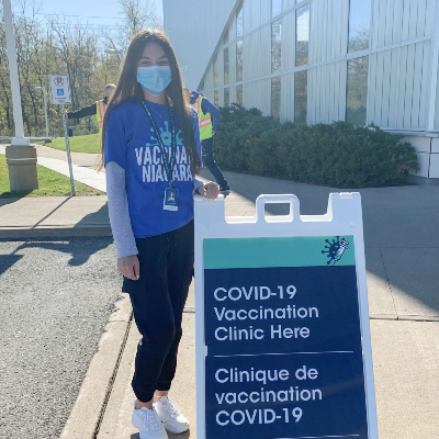 Brock University student volunteering at a COVID-19 vaccination clinic