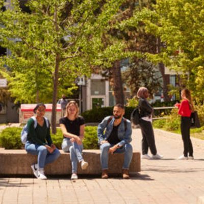 Students sitting and walking on campus