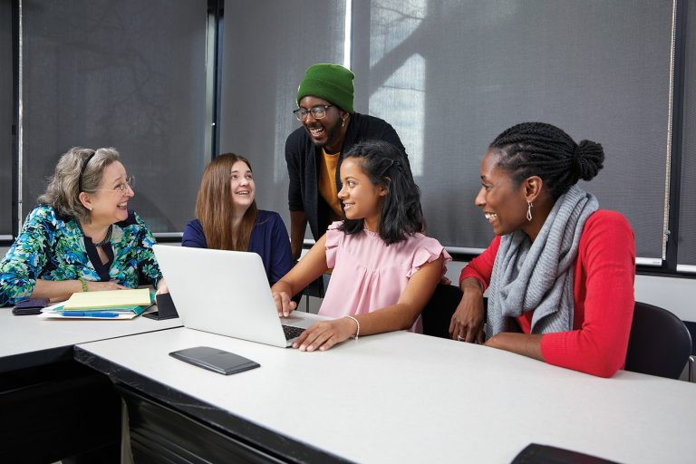 Teachers and students at York University working together on a technology project